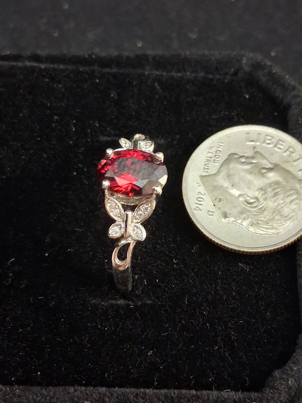 Cubic zirconia garnet colored ring with butterflies.