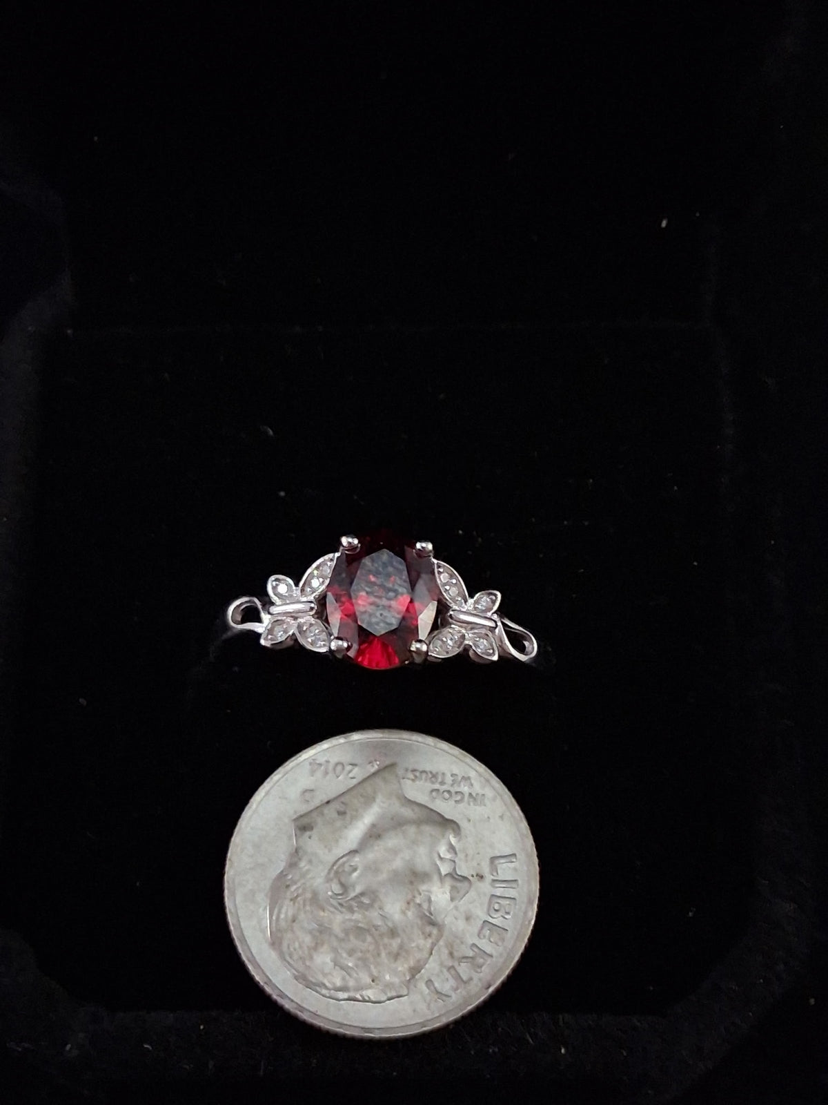 Cubic zirconia garnet colored ring with butterflies.